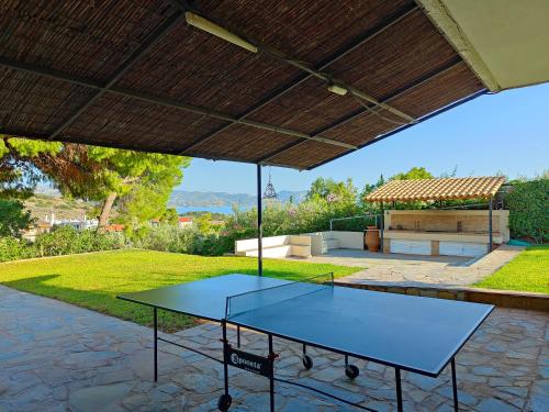 a ping pong table on a patio in a house at Summer Breeze Villa in Saronic Gulf in Anavyssos