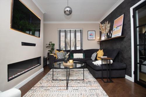 a living room with a couch and a table at The Longsands Home- Coastal Retreat with Hot Tub in Cullercoats