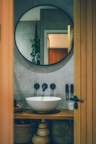 a bathroom with a sink and a mirror at The Longsands Home- Coastal Retreat with Hot Tub in Cullercoats