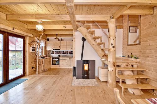 a log cabin with a spiral staircase in a living room at Prawie na końcu drogi in Skomielna Biała