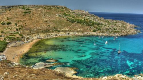 an aerial view of a beach with boats in the water at Claureece Court Mgarr in Mġarr