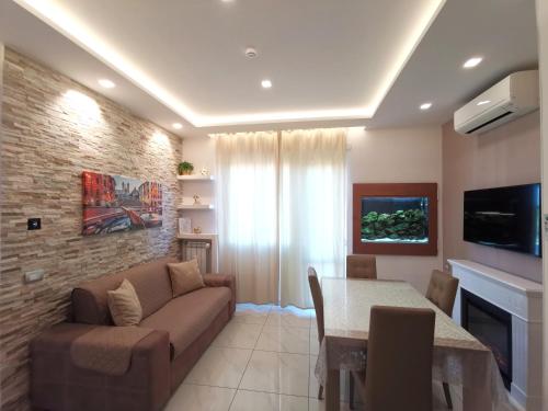 a living room with a couch and a table at Giglio Luxury Apartment - Chroma Italy in Rome