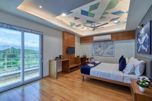 a bedroom with a bed and a large window at The Scenic Unity in Garudeshwar