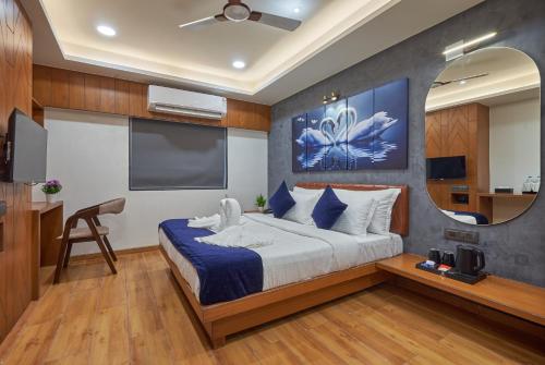 a bedroom with a large bed and a flat screen tv at The Scenic Unity in Garudeshwar