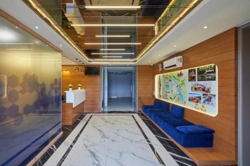 a lobby with a blue couch and wooden walls at The Scenic Unity in Garudeshwar