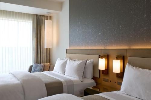 a hotel room with two beds and a window at The Westin Raleigh-Durham Airport in Raleigh