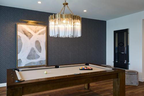 a room with a pool table and a chandelier at The Westin Raleigh-Durham Airport in Raleigh