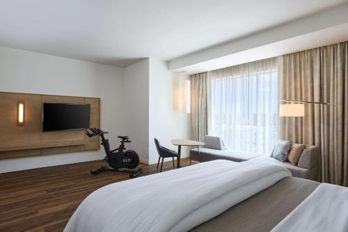 a hotel room with a large bed and a television at The Westin Raleigh-Durham Airport in Raleigh