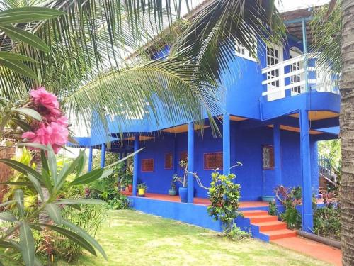 a blue building with stairs in front of it at Charming blue house with kitchen parking and garden in Canoa Quebrada