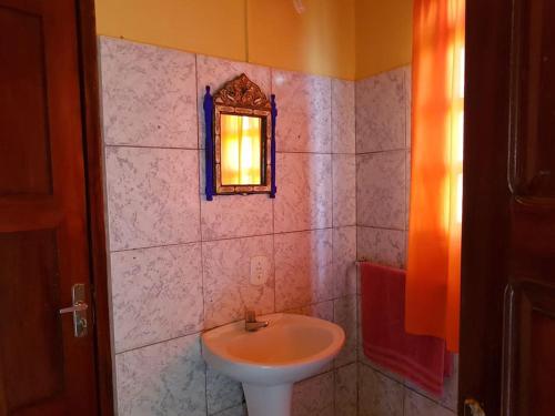 y baño con lavabo y espejo. en VILLA com Wi-Fi, cozinha, parking, Canoa Quebrada zona centro, jardim tropical, tudu prossimo a pe en Canoa Quebrada