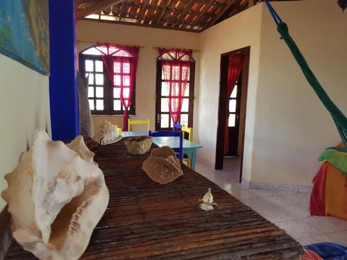 a room with a room with a table and a room with a room at Charming blue house with kitchen parking and garden in Canoa Quebrada
