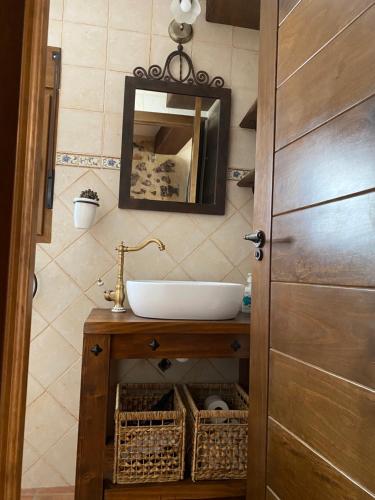 y baño con lavabo y espejo. en Casa Rural El Aljibe, en San Agustín