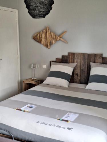 1 dormitorio con 1 cama grande y cabecero de madera en Woodland's House, en Hermanville-sur-Mer