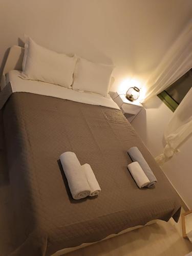 a bedroom with a bed with two towels on it at Sigma Acropolis GF in Athens