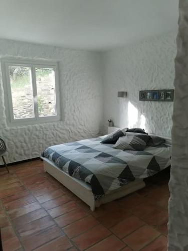 une chambre avec un lit et une fenêtre dans l'établissement Dépendance dans Mas traditionnel avec piscine, à Argelès-sur-Mer