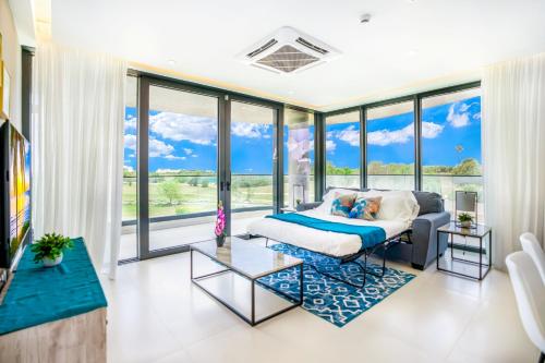 a bedroom with a bed and a large window at Luxury Oceanview 1BR on beach in Cupecoy