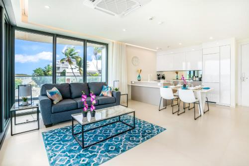 a living room with a couch and a table at Luxury Oceanview 1BR on beach in Cupecoy