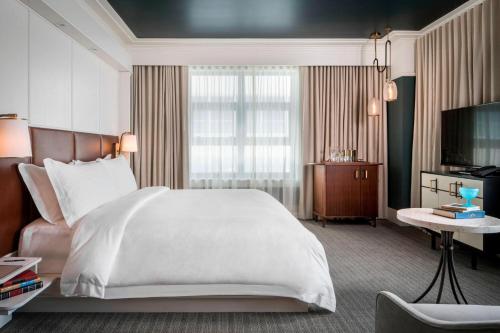 a hotel room with a bed and a television at Perry Lane Hotel, a Luxury Collection Hotel, Savannah in Savannah