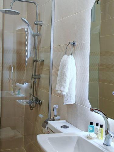 a bathroom with a shower and a sink and a shower at iHome Petra in Wadi Musa
