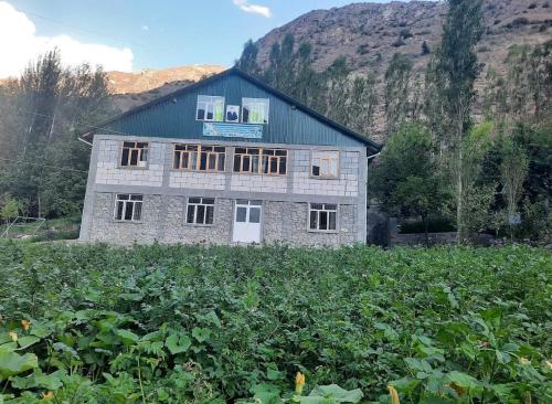 a stone house in the middle of a field at Jumaboy Guesthouse 