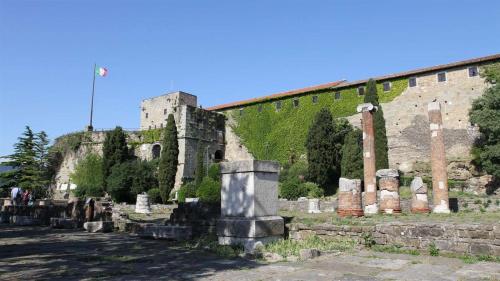 an old castle with a bunch of graves in front of it at M's Residences Maiolica in Trieste