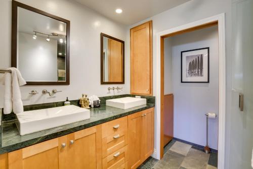 a bathroom with a sink and a mirror at Stunning Solana Beach Condo with Community Pools! in Solana Beach
