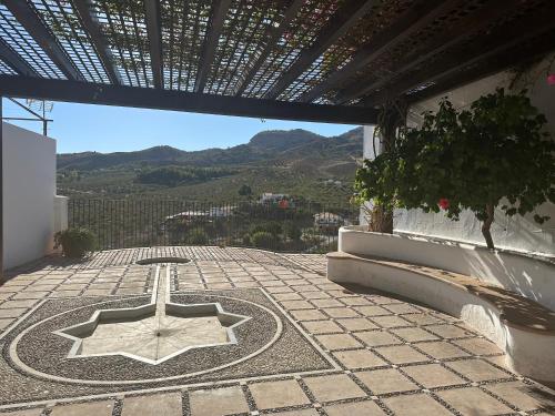 a building with a star on the ground on a patio at MiraSierraHome... Tú hogar de vacaciones! in Alora