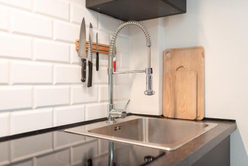 a kitchen counter with a sink and a cutting board at HK apartments by Správa ubytka in Rokytnice nad Jizerou