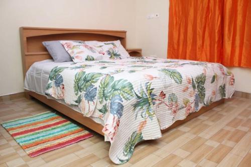 a bedroom with a bed and a rug on the floor at CNC Rehoboth Villa in Accra