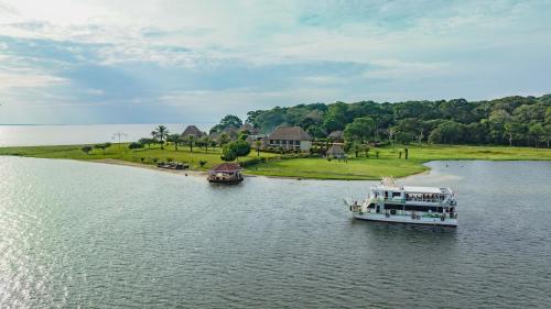 two boats in the water near a resort at Victoria Forest Resort in Kalangala