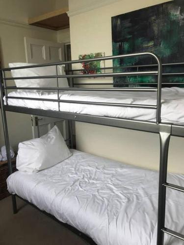 a couple of bunk beds in a room at Stunning Arty Apartment in the heart of Clifton in Bristol