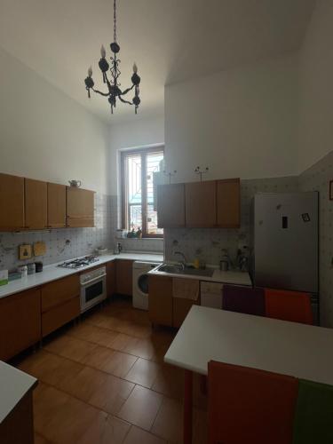 a kitchen with a refrigerator and a table in it at Viromar in Naples