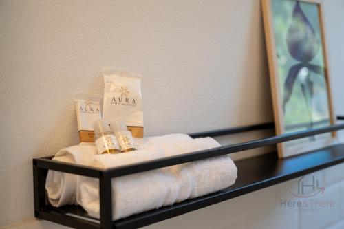 a bathroom shelf with towels and a mirror at [Penthouse with Terrace] • Sea 5Min • Trains 4Min in Varazze