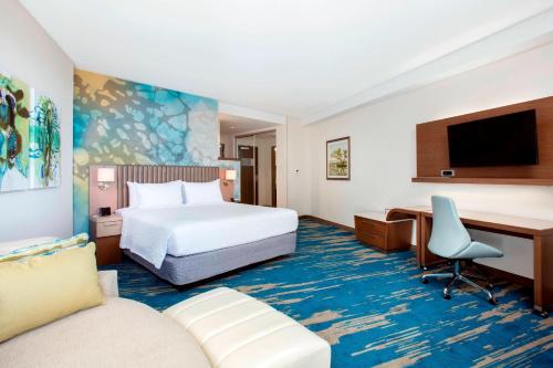 a hotel room with a bed and a desk at Courtyard by Marriott Faro Blanco Resort in Marathon