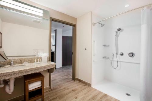 a bathroom with a shower and a sink at Courtyard by Marriott Faro Blanco Resort in Marathon