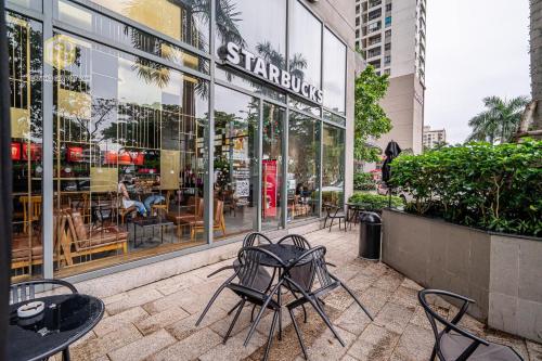 a group of chairs and tables in front of a store at Cozy Apartment in District 4-City Center - Free Netflix - canhogiatot24h in Ho Chi Minh City