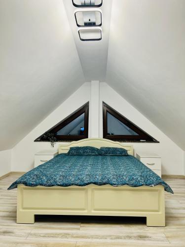 a bedroom with a bed in a attic at Altheda Living Tiny House in Suceava