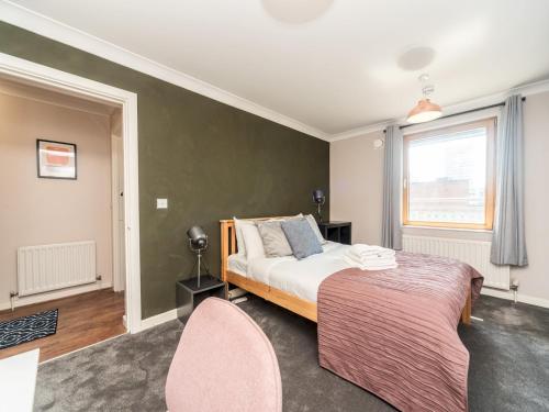 a bedroom with a bed and a window at Pass the Keys Sidney Street Lovely one bed flat - great base to explore London in London