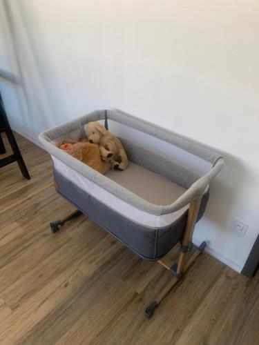 a stuffed teddy bear laying on a bed at Apartmán až pro 9 osob in Humpolec