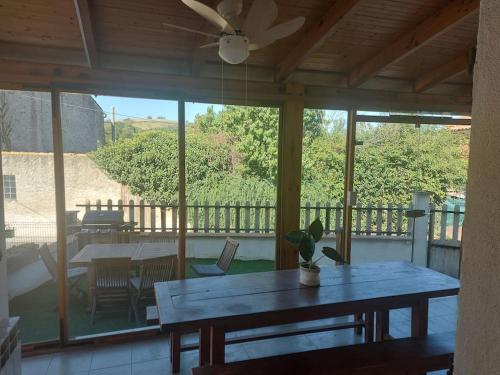 a large screened in porch with a table and chairs at La Parent'aise un brin d'Auvergne 