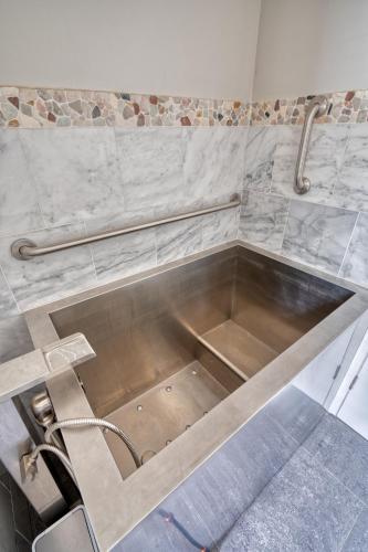 a metal sink in a bathroom with a sink at Welcome to The Village Hideout, Steps to the Village, Resort, Golf, SHARC, AC, Hot-tub, Grill and Bikes in Sunriver