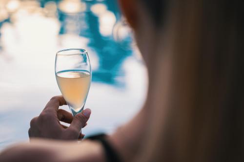 a person is holding a glass of champagne at Emesh Boutique Suite in Agrigento