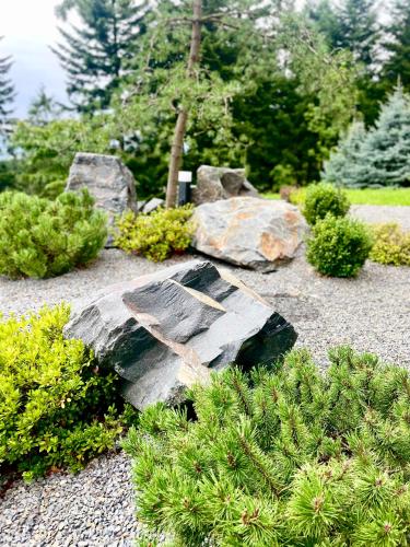a rock with a cross on it in a garden at Vila na Spině in Vsetín