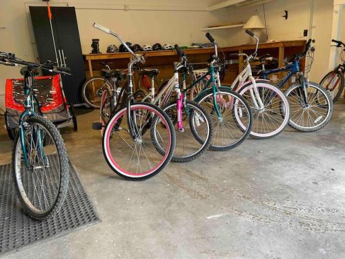 a group of bikes parked in a garage at Welcome to The Village Hideout, Steps to the Village, Resort, Golf, SHARC, AC, Hot-tub, Grill and Bikes in Sunriver
