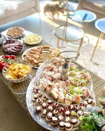 a table topped with plates of food and appetizers at Vila na Spině in Vsetín