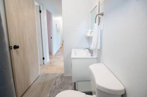 a white bathroom with a toilet and a sink at 3 Santurce 2 Bedroom 1Bathroom Apt in San Juan