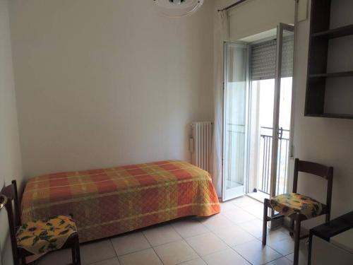 Tempat tidur dalam kamar di Casa vacanza “Belvedere sullo Ionio “