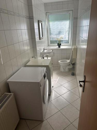a white bathroom with a toilet and a sink at Monteurzimmer Rochau in Rochau