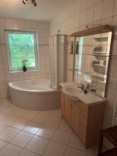 a bathroom with a tub and a sink at Monteurzimmer Rochau in Rochau