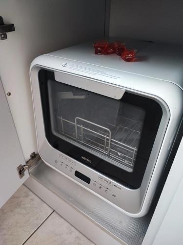 a toaster oven sitting inside of a refrigerator at Ferienwohnung in Niebüll, Kreis Nordfriesland in Niebüll